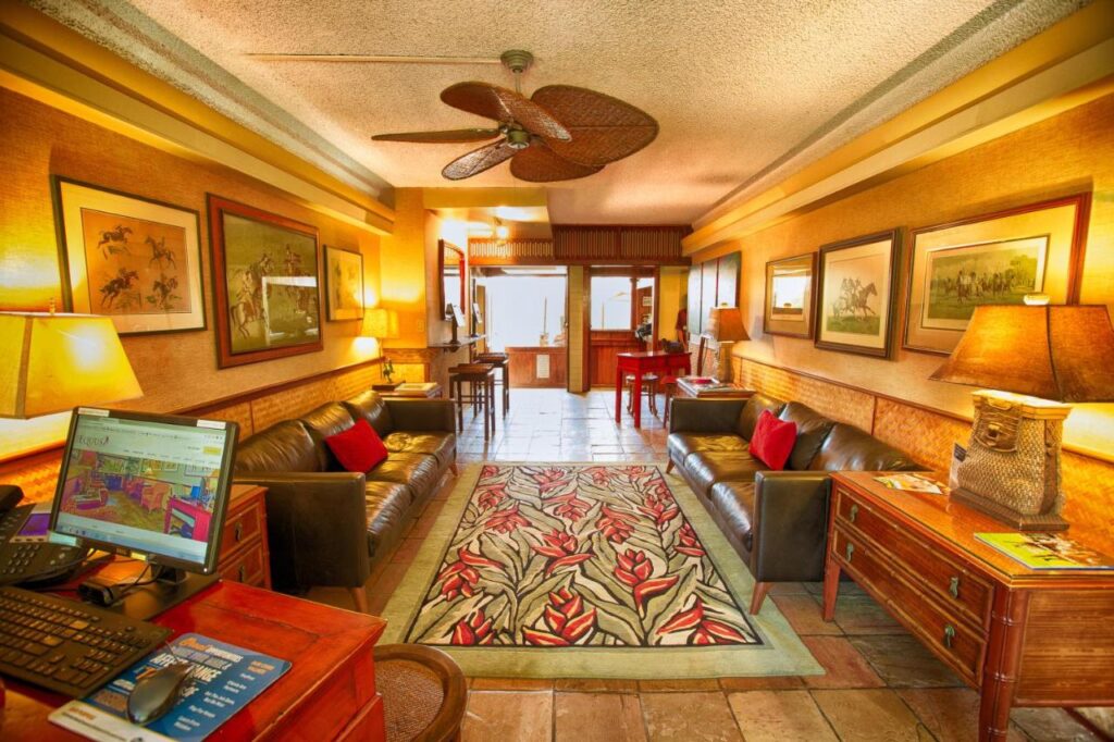 The Equus lobby in warm lighting and carpet surrounded by chairs