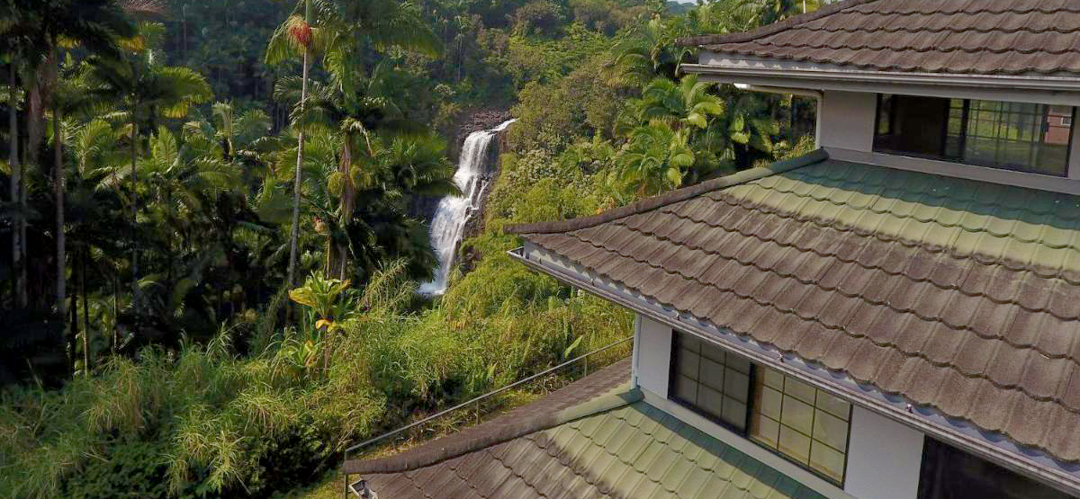 The Inn at Kulaniapia Falls with the waterfall in the background and Inn upfront