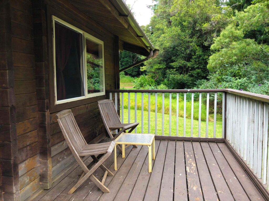 The balcony view of The Cabins at Koke‘e State Park with greenery in the background