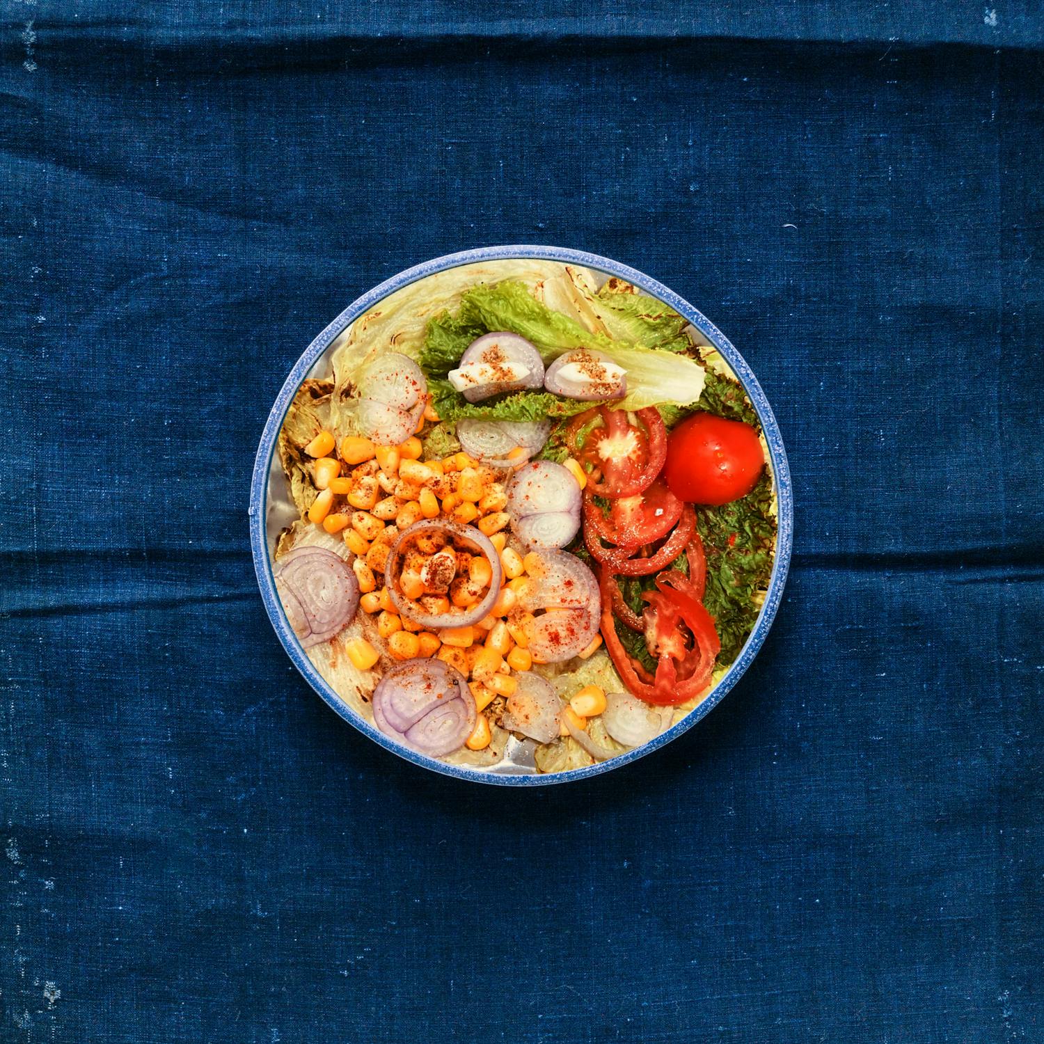 Hawaiian vegetable bowl on a blue wooden surface