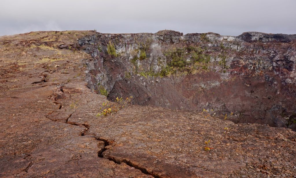 Mauna Ulu stands as a volcanic cone situated within the eastern rift zone of the Kīlauea volcano on Hawaii Island and there's a crack running along towards the camera