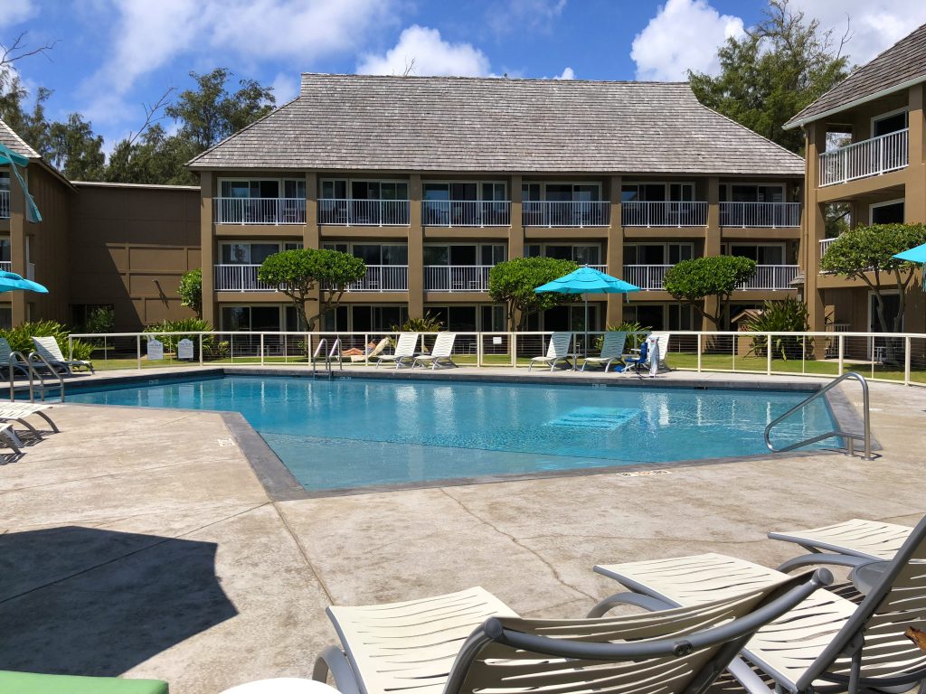 A view of ISO Resort's pool and chairs surrounding it and it is only property Kauai's east shore that sits at the ocean's edge