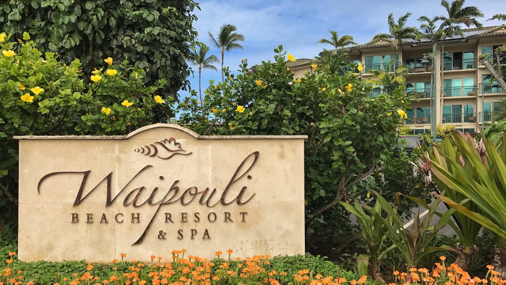 A sign in of condos saying Waipouli Beach Resort & Spa that is nestled along Kauai's eastern shore