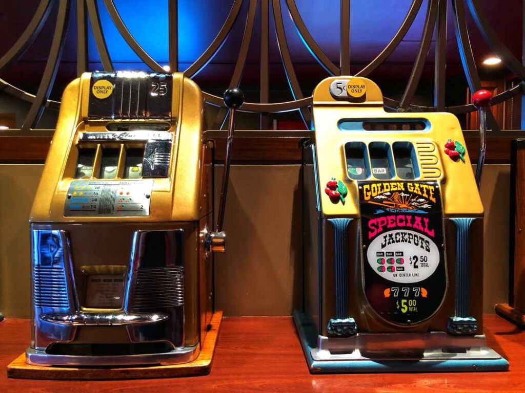 Two yellow casino machines where one of them says Golden Gate Special Jackpot.