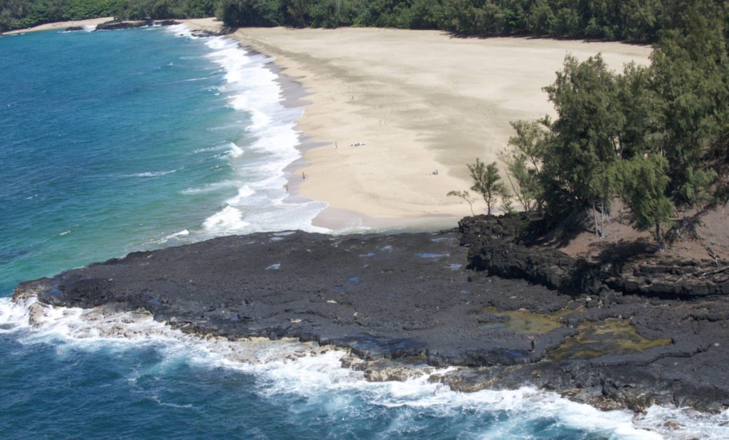 Lumaha‘i Beach featuring clean pearl and crashing waves yet a black rocky area rugged on the north shore of Kauai, Hawaii.