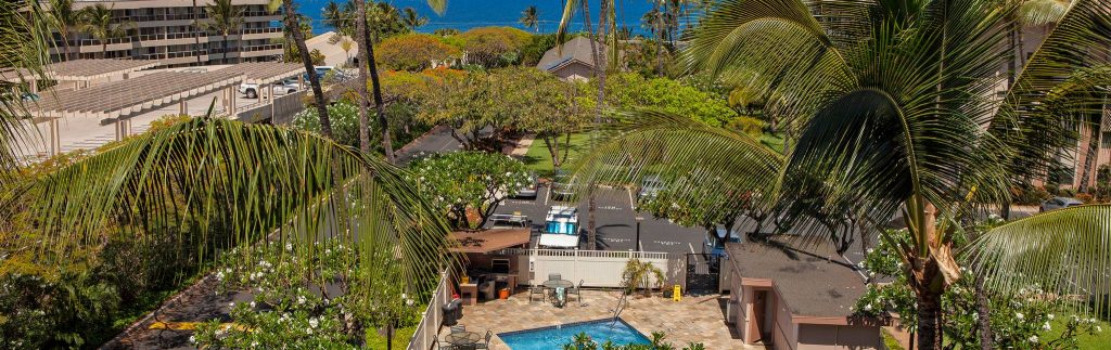 Far view of Kihei Akahi with the pool, parking lot, and roads seen