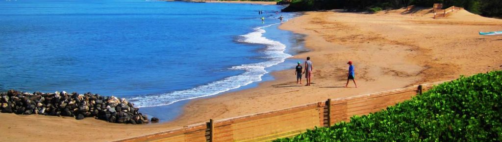 Kihei Bay Vista beachside view with people walking on the shore