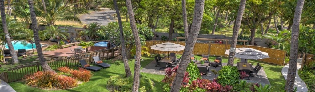 Far away shot of Kohea Kai Maui outdoor area with umbrellas and chairs