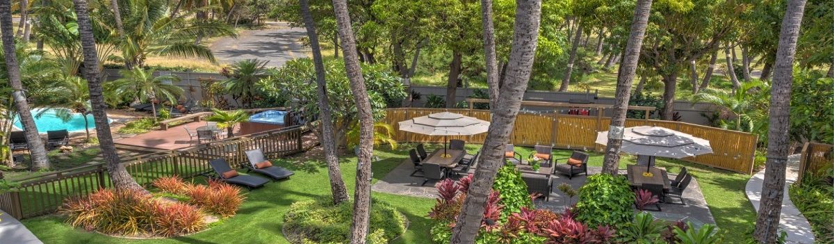 Far away shot of Kohea Kai Maui outdoor area with umbrellas and chairs
