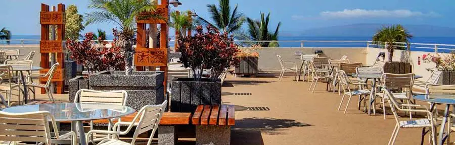 ROYAL MAUIAN Royal Mauian rooftop area where it's full of decorations, nature, chairs and tables
