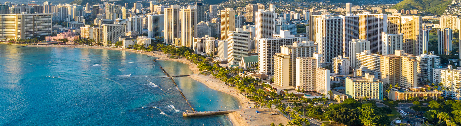 A far out view of The Regency on Beachwalk in Waikiki city with the beach and ocean next to it