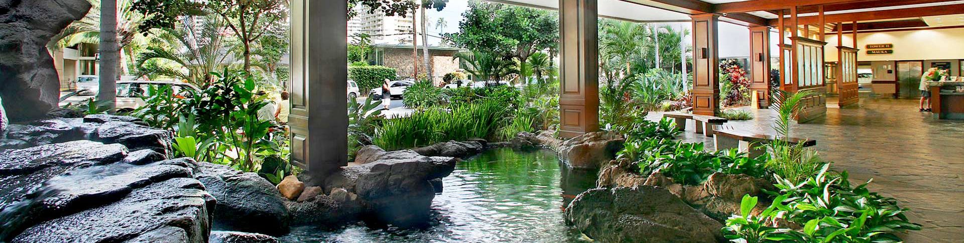 Waikiki Banyan lobby with a pond and open garden