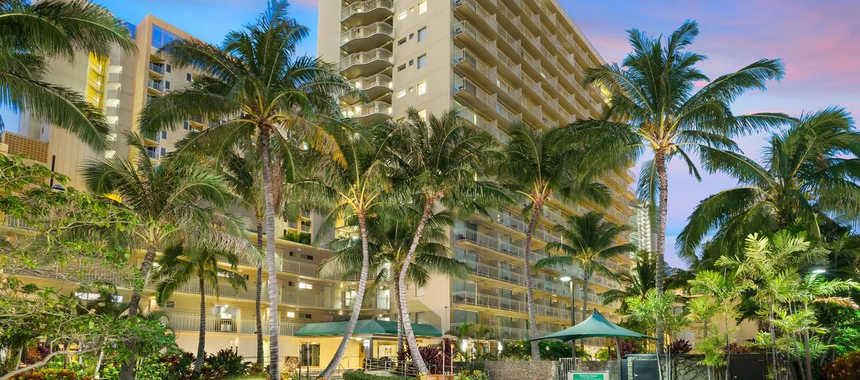 Courtyard by Marriott Waikiki Beach building surrounded by palm trees