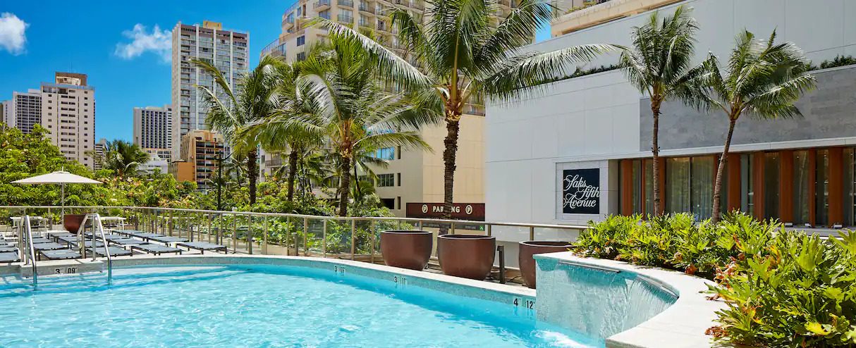 Hilton Garden Inn Waikiki Beach and the pool outside along the building