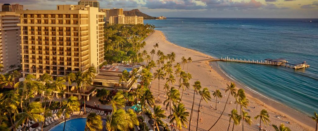 Far out of Hilton Hawaiian Village building on Waikiki Beach with the sea on the right side