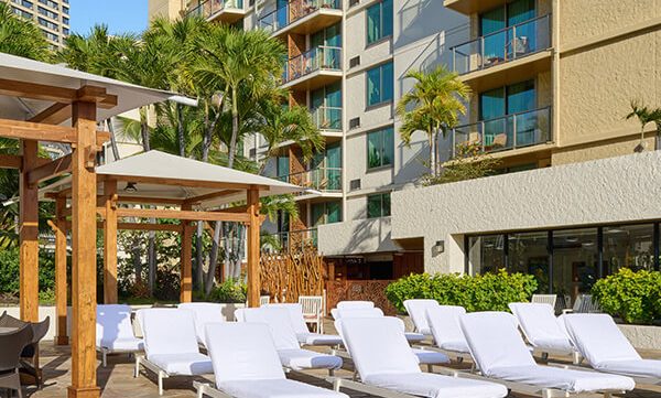 Waikiki Beach Hotel view of their white beach chairs lined up