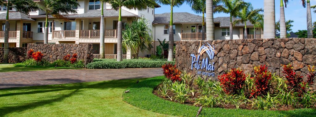 The front building view of Pili Mai at Po‘ipu with the logo on the right