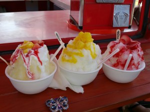 3 Bowls of Shaved Ice ranging from mango, strawberry or both on a red colored table