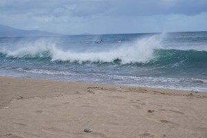 A Hawaiian ocean wave hitting the beach shore